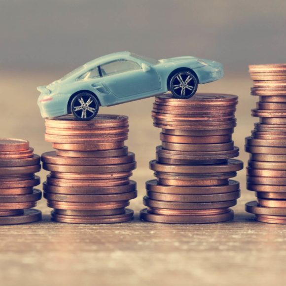 model of a car on coins