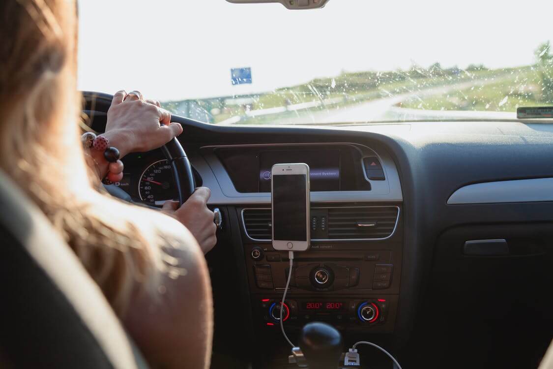 a person driving with the help of GPS navigation