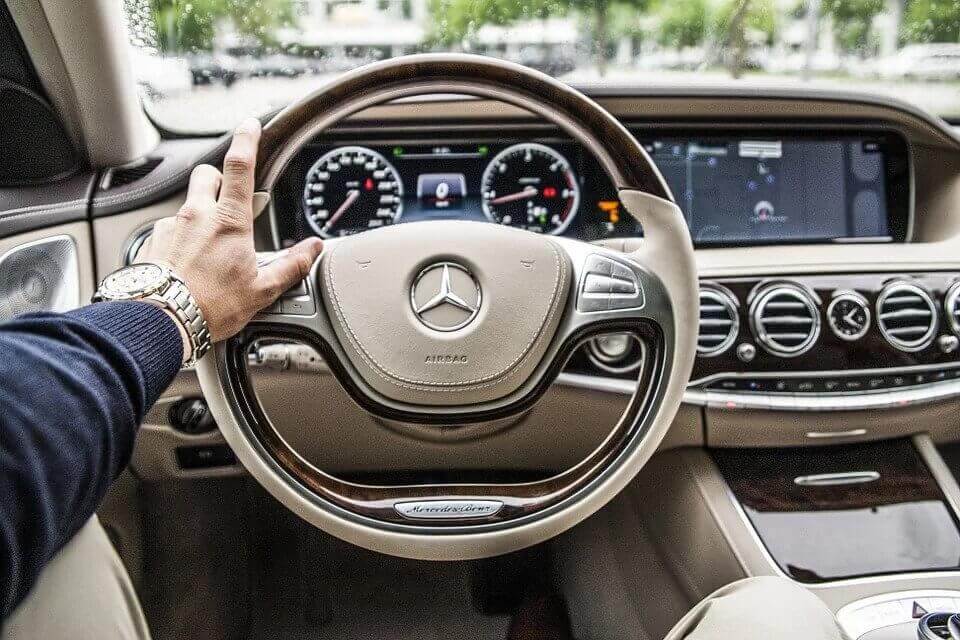 Hand on Car Steering Wheel