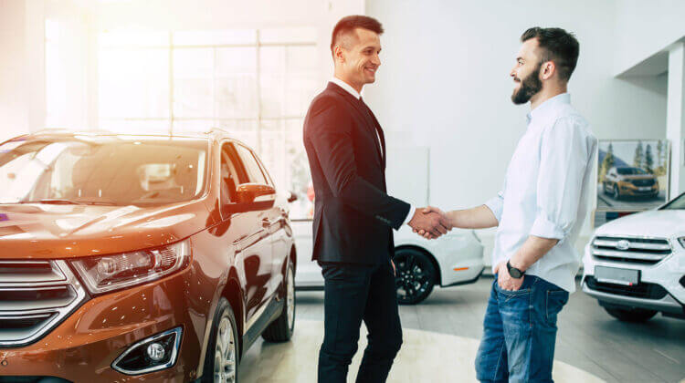 Two men shaking hands at the dealership