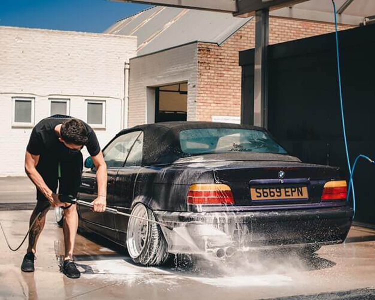 A person splashing a car.