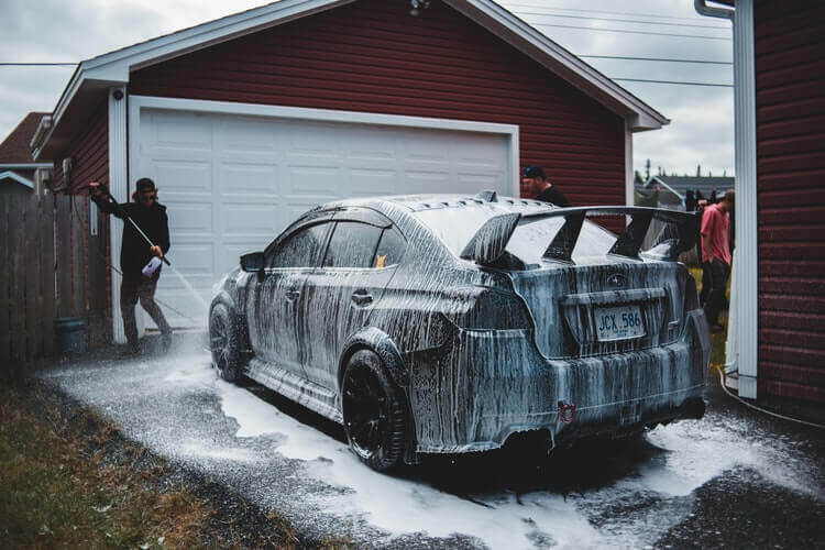 A person cleaning the car.