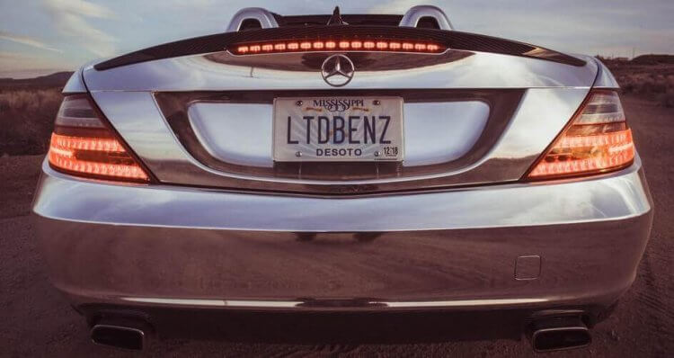 An image of a silver Mercedes Benz on the road