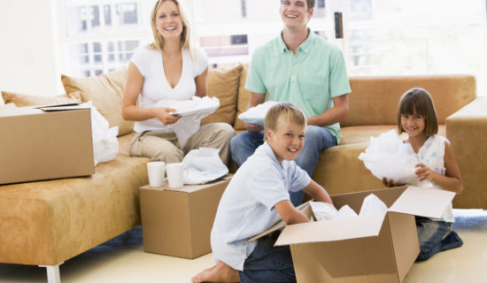 A family of four packing for moving together