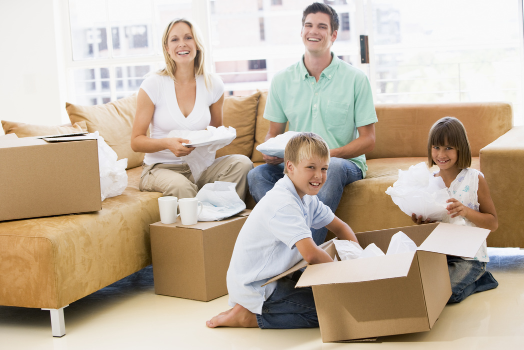 A family of four packing for moving together