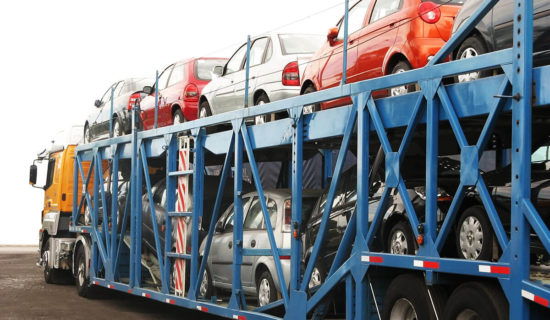 Auto transport company shipping cars on open trailer