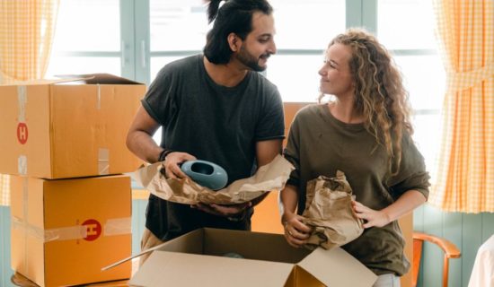 Couple laughing before cross-country moving