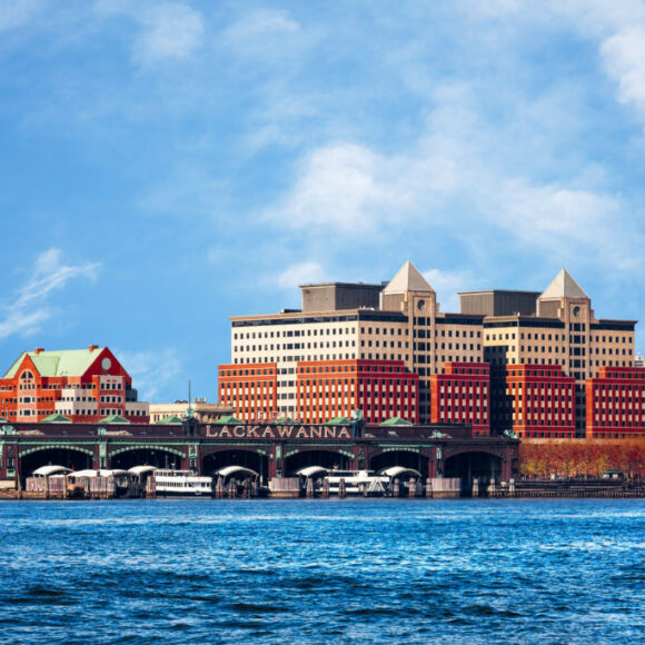 Hoboken, New Jersey waterfront and skyline viewed from the Hudson River. The historic Lackawanna train terminal, built 1907, is seen in the foreground.