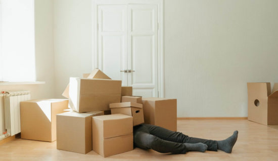 person lying on brown cardboard boxes