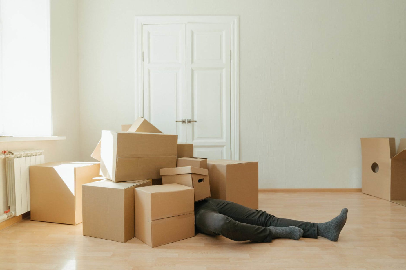 person lying on brown cardboard boxes