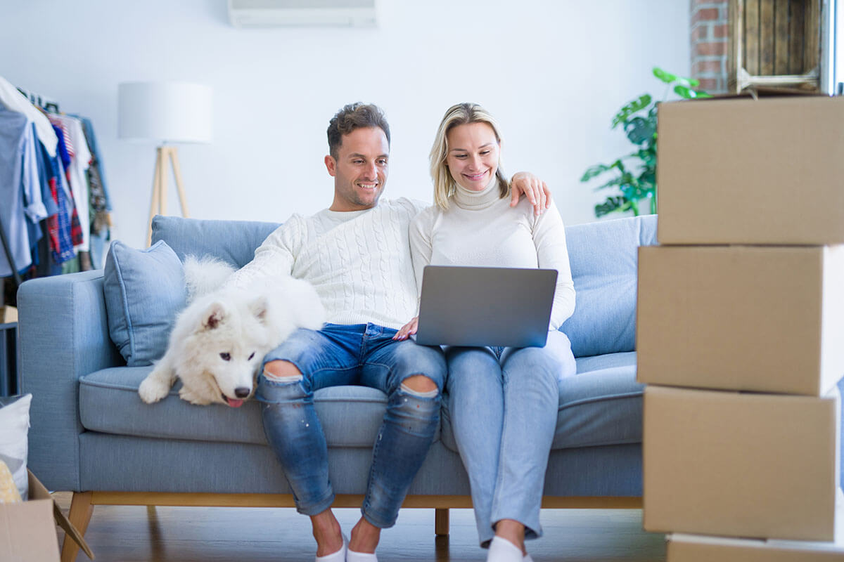 Couple sitting on the floor surrounded by boxes