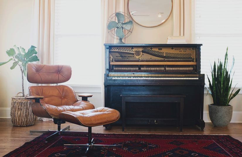 An upright piano in a living room ready for cross country moving