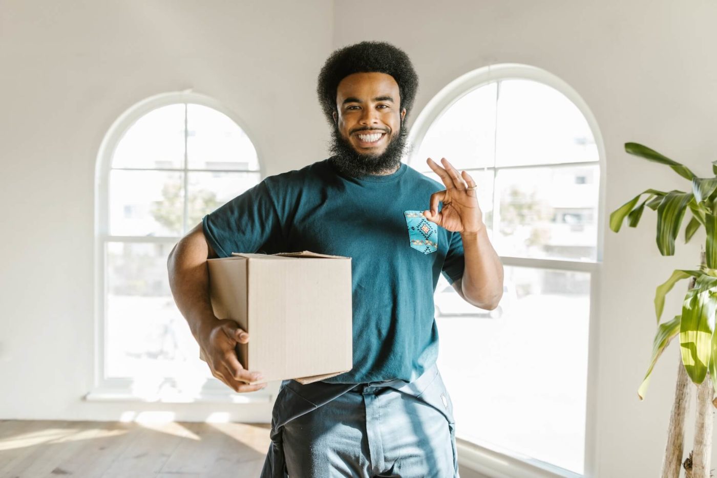A happy man holding a box