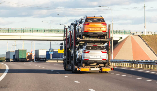 Vehicles getting transported on an open trailer