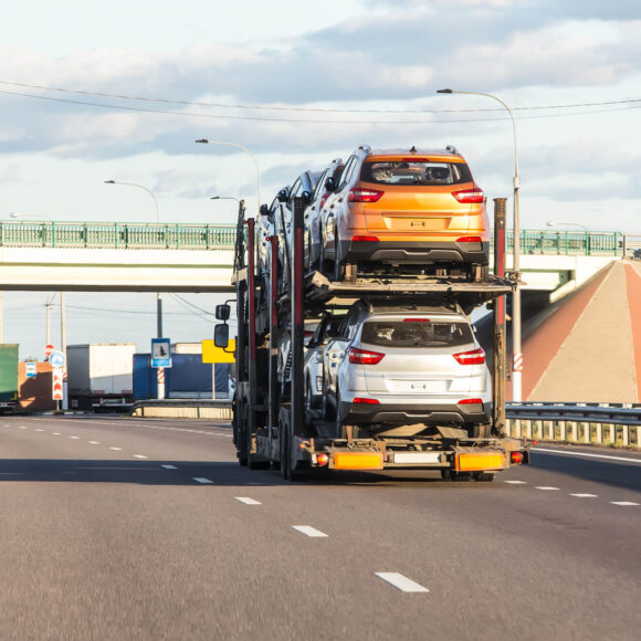 Vehicles getting transported on an open trailer
