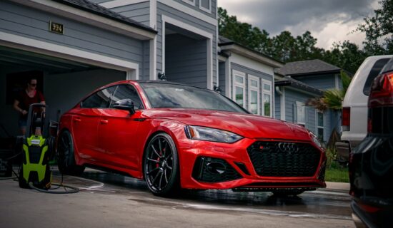 A red Audi on a driveway