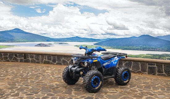 Blue quad bike in front of mountains