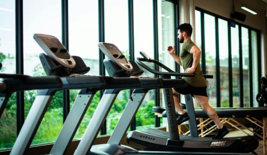 Man running on a treadmill in a gym