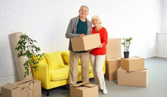 Mature couple with boxes after moving into new house