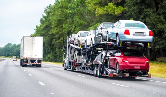 Truck trailer hauler transportation, commercial transport hauling brand new cars for auto dealership on Florida highway road