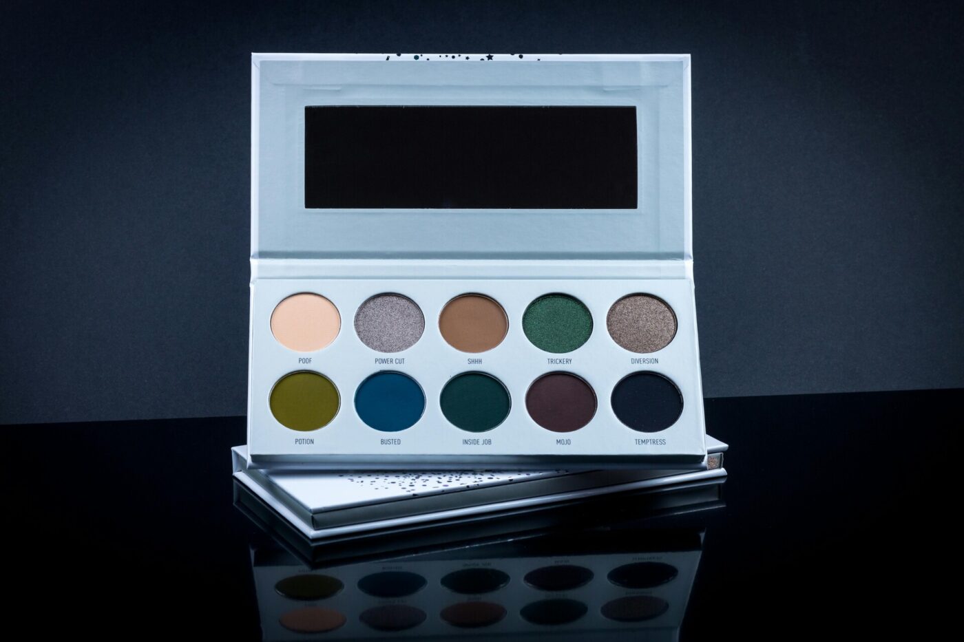 An eyeshadow palette with a mirror