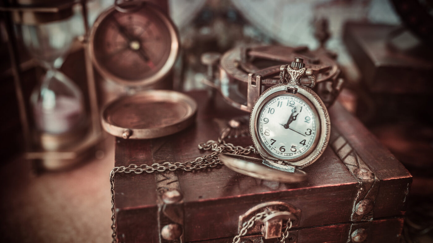 An antique watch on a suitcase