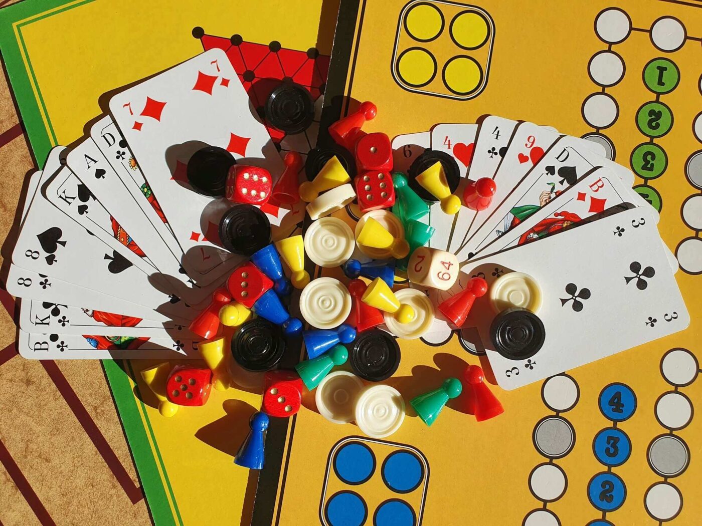 Various game pieces, dice, and cards on a board