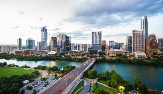 Long exposure nighttime view of the Austin, Texas skyline and city traffic.